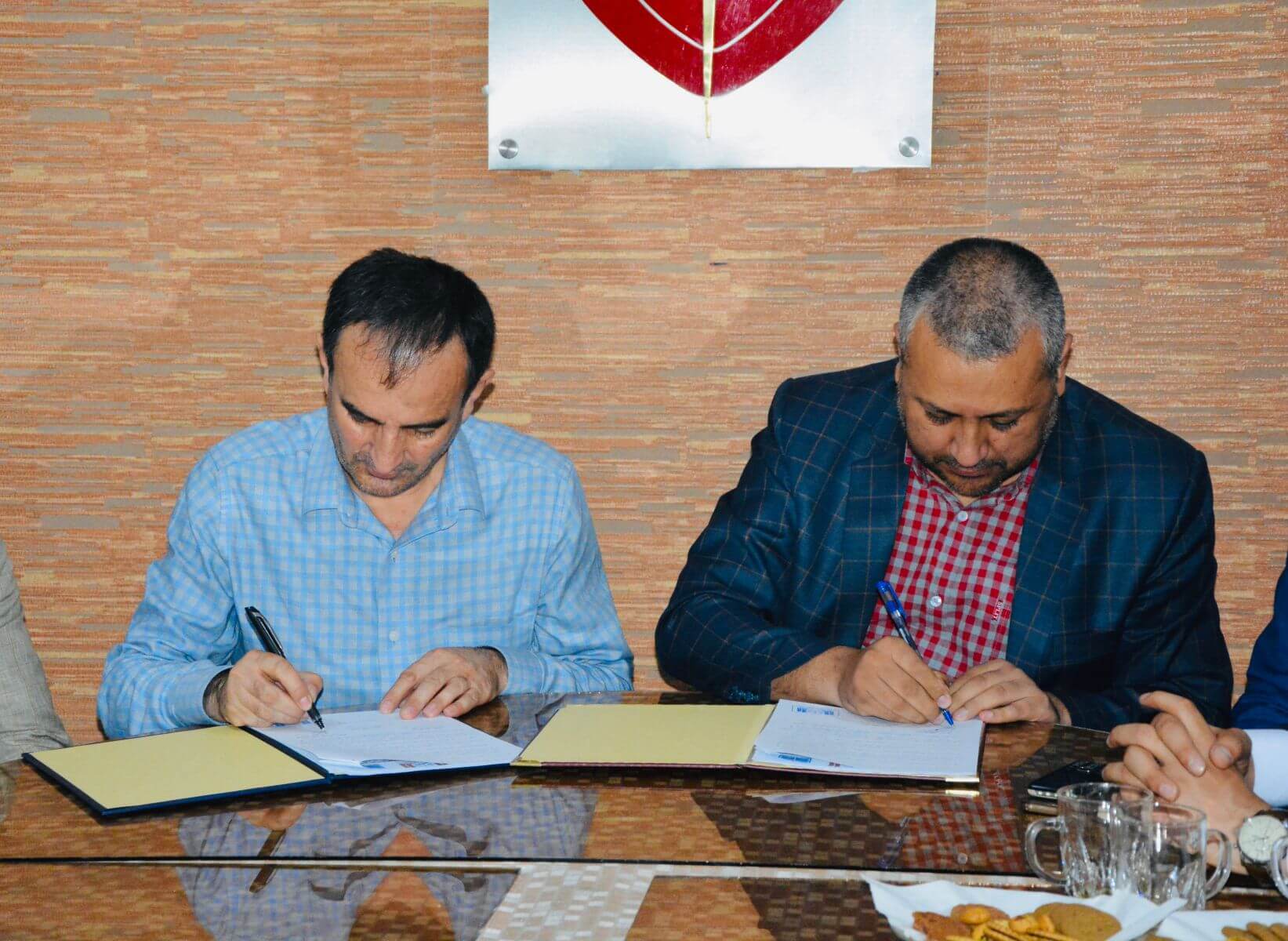 From the left Prof. Khaliluraman Sarwary, Director of AELSO Academy and Mr. Sayed Mustafa Sayedy the Vice President of Rana University During the signing of MoU.