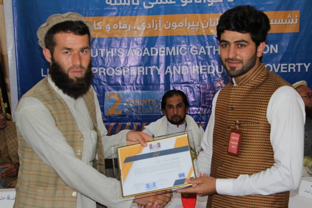 Participants while receiving their certificate of participation.