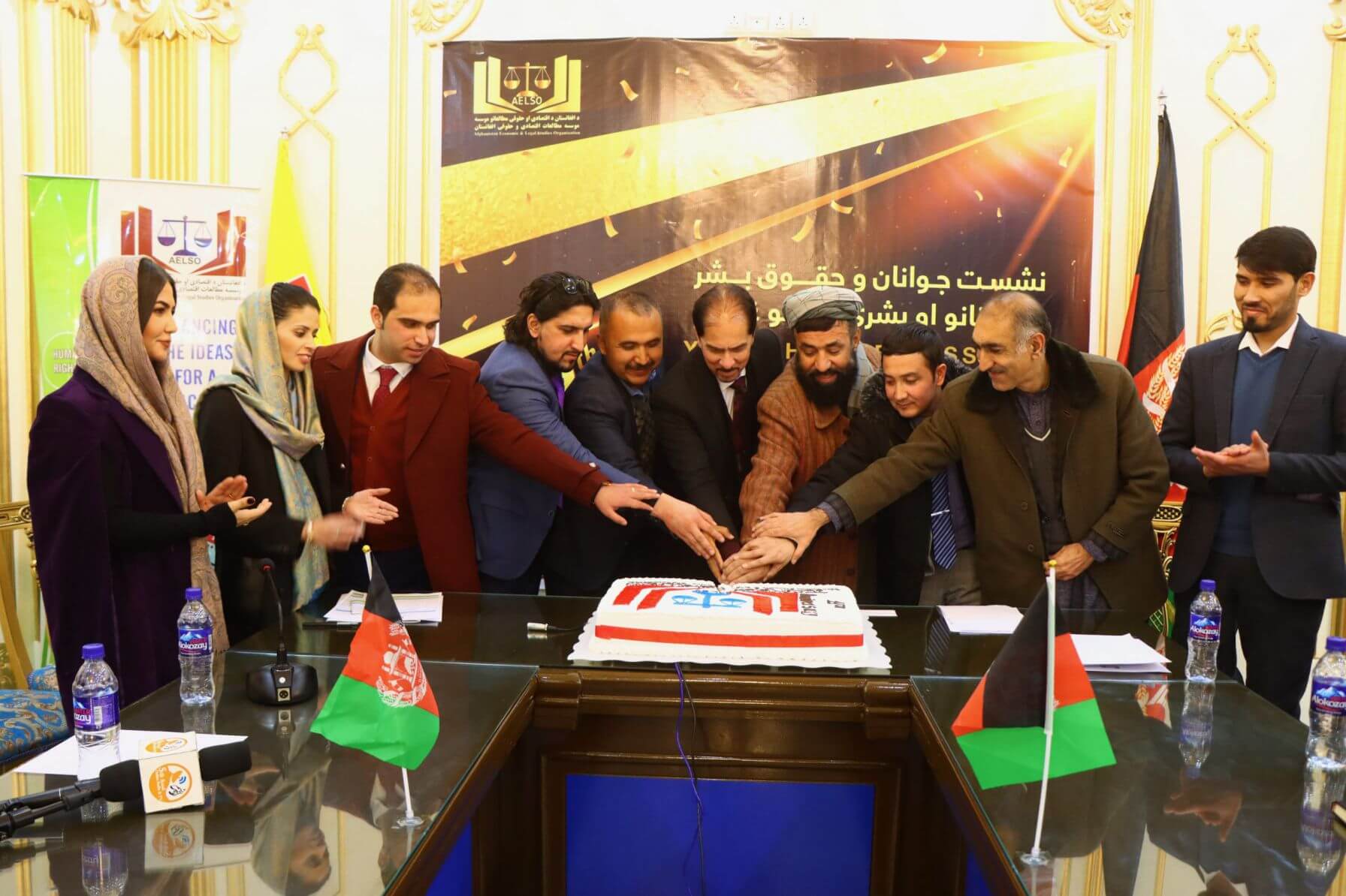 While cutting the anniversary cake by all the speakers of the summit...